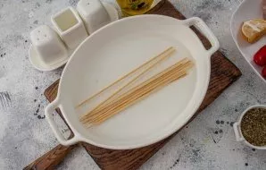 Shorten the skewers to the size you need and dip in cold water for 10 minutes. This is done so that during frying the product does not ab...