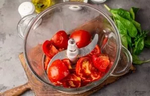 Cut the tomatoes into slices, put in a chopper. You can also use a stationary blender or meat grinder.