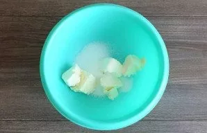 Put the soft butter in the bowl. Add sugar. Crush lightly with a fork.