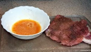 Break an egg into a bowl, add salt, pepper to taste and beat a little.