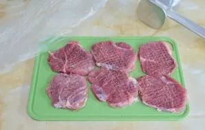 Cut the pork into portions and beat it a little with a kitchen hammer. When whipping, cover the meat with a film so that the edges of the...