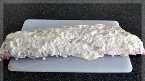 In a bowl, mix mayonnaise, onion and garlic. Rub the ribs with this mixture.