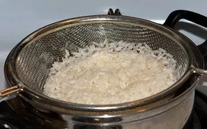 First, boil the rice in salted water until half cooked. It will take about 10 minutes.