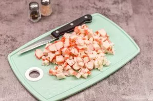 Peel the crab sticks, then cut the sticks into small cubes.