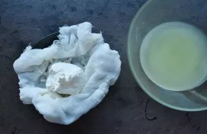 Tie the ends of the gauze into a knot, put a colander with a gauze bag on a container into which, as the kefir melts, whey will drain. Wh...