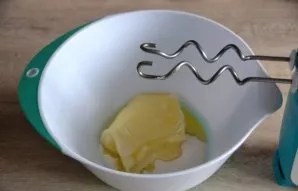 Beat sugar with soft butter until fluffy.