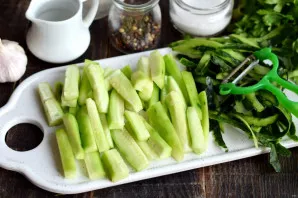 Peel the cucumbers, so they will turn out softer. The skin of a young fruit can not be peeled. Cut the pulp into cubes of about the same ...