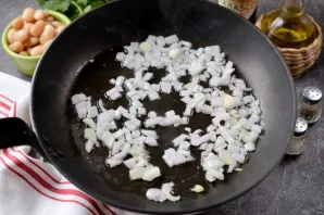 Heat vegetable oil in a pan, add chopped onion to it, fry until golden for a few minutes.