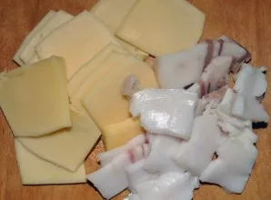 Cheese should be cut into thin pieces, and if you wish, you can grate. Also thinly chop the bacon. If the meat is fatty, then bacon can n...