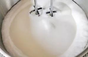 Pour the egg whites into a clean, dry mixer bowl, add a pinch of salt and beat on medium speed until soft peaks form.