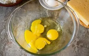 Break the eggs into a large bowl and add salt.