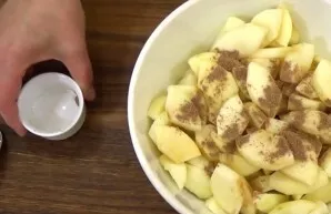 Use a spatula to stir the dough. Peel the apples and cut into small pieces. Mix them with cinnamon and put them in a pan, previously line...