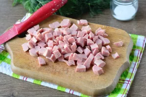Cut the cooked sausage into cubes.