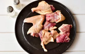 Cut the duck into pieces and place on a baking sheet.