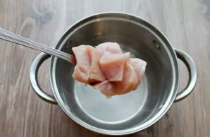 Wash the chicken fillet and cut into cubes. Pour water into a saucepan, salt and put the fillet. Bring to a boil and cook, scraping off t...