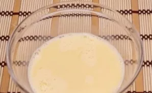 In a deep bowl, beat the eggs with milk.