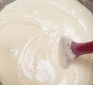 Gradually add flour to the egg-sugar mixture, stir the dough with a wooden spoon.