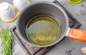Pour oil into a small saucepan and heat to about 40-50 degrees. No need to boil!