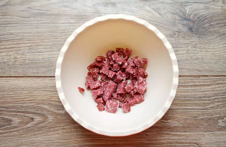 Cut the smoked sausage into small cubes and place in a bowl.
