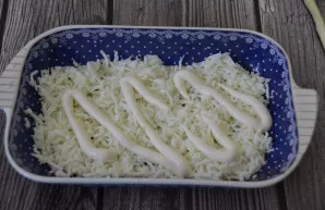 The first layer of the salad is grated egg whites (5 pcs.), mayonnaise on top.