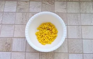 Put the canned corn in a bowl.