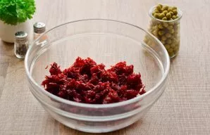 Grate the beets on a fine grater to make the salad softer. Transfer the beets to a salad bowl.