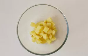 Rinse the potatoes and cook until tender. Peel and cut into cubes.