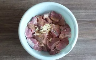 Prepare the meat. Rinse, dry. Cut into pieces the size of a matchbox. Transfer to a bowl. Add chopped garlic, black pepper and bell peppe...