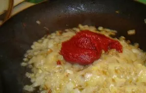 Peel the onion and cut into small pieces. Fry the vegetable with tomato paste. Cooking time  5 minutes.