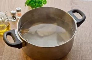 Pour two liters of water into the pot, bring to a boil and put the chicken fillet in it. Boil the broth over low heat for 30 minutes, the...
