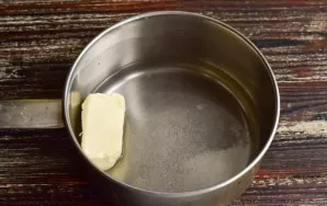 Pour water into a saucepan, add a pinch of salt and add butter.
