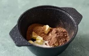 In a saucepan, mix sour cream, cocoa powder, diced butter, brown sugar and agave syrup. Heat over medium heat until sugar and butter diss...