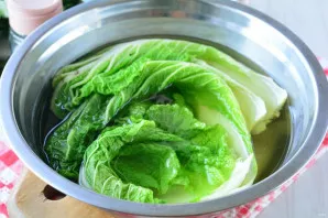 Separate the cabbage leaves and immerse in hot water for 10 minutes. The leaves will become soft and it will be easy to bend them.