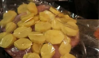 Put the chicken in a baking sleeve with slices of potatoes on top. We also salted the potatoes.