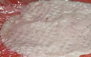 Cut the chicken fillet lengthwise, wrap it in cling film and knock it out on both sides.