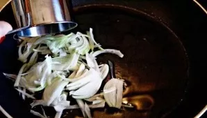 Heat olive oil in a pan, add onion to it. Bake until transparent (just a couple of minutes).