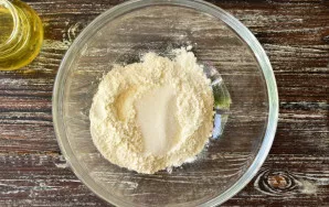 Pour flour into a bowl, add sugar.