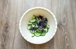 Separate the basil leaves from the stems, chop and add to the cucumbers.