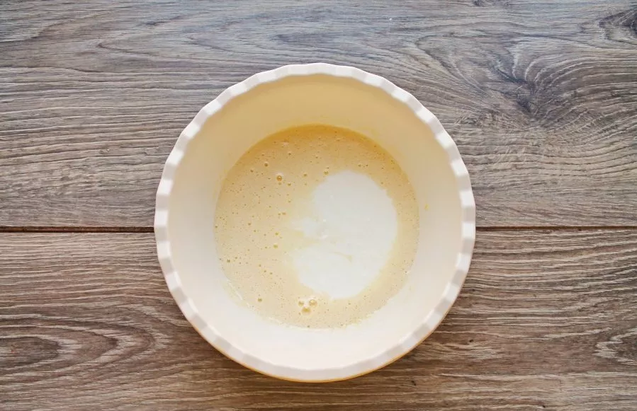 Pour milk into the mass.