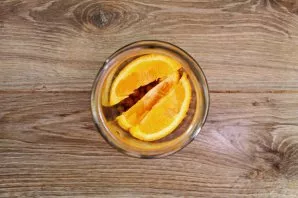 Cut the orange into slices and put on top of the berries.