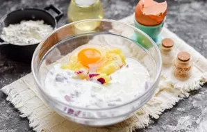 Add kefir, break an egg into a bowl with potatoes.