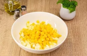 Add canned corn to the eggs.