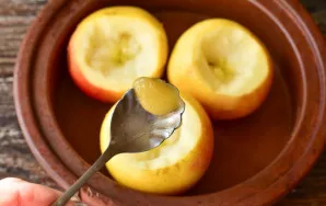 Put half a teaspoon of honey in each apple.