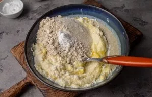 Add both types of flour, baking powder.