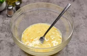 Beat eggs and milk with a fork.