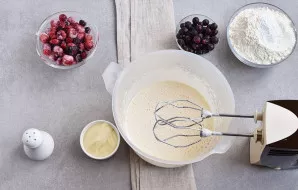 While continuing to beat, pour vegetable oil in a thin stream.