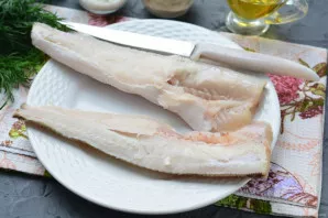 Cut the hake lengthwise into two equal parts.