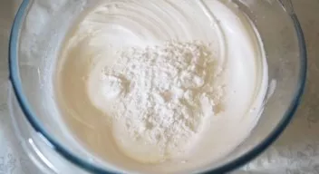 Pour potato starch into the whipped proteins and carefully mix from the bottom to the top.