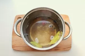 While the pork is marinating in kefir, prepare the first marinade. To do this, pour water into a pot, add salt, sugar, and bring to a boi...