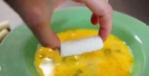 Take one stick of Mozzarella cheese, roll in flour, then dip in a mixture of eggs and milk, then roll in a mixture of breadcrumbs and par...